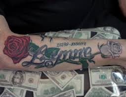 The elements connected to the name tattoo design below greatly enhances the overall outlook of the design with a mixture of different colors. Realistic Roses With Name By Rafael Marte Tattoonow