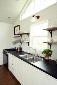 Single Wall Sconce Light Fixture Some Floating Wood Shelves Black Kitchen Counter Double Stainless S Diy Kitchen Countertops Kitchen Design Kitchen Countertops