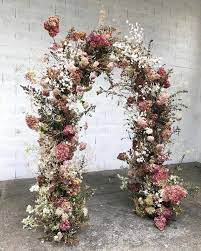 Use the same faux flowers in your bridesmaids bouquets. 23 Creative And Beautiful Wedding Arch Ideas And How To Make Your Own Floral Arch Wedding Wedding Arch Flowers Wedding Flower Inspiration