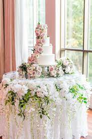 Elegant Wedding Cake Display With Orchids Wisteria And Greenery Draping Undern Wedding Cake Display Wedding Cake Display Table Wedding Cake Table Decorations