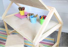I did colors to match my boys room decor, so we started by painting the desk green, then we taped off a chevron pattern and added more color to the design. Diy House Play Table Desk Stool Free Plans Jaime Costiglio