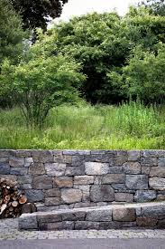 A Tightly Edited Plant List Including Sugar Maples Fothergilla And Shadblow Serviceberry Connects Th Stone Landscaping Stone Walls Garden Rock Wall Gardens