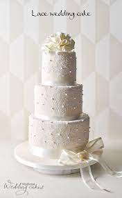 This Stunning Ivory Wedding Cake Is Covered In Sugar Paste Icing And Expertly Hand Decorated W Wedding Cake Fresh Flowers Wedding Cake Pearls Lace Wedding Cake
