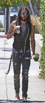 Russell brand, has a tattoo on their right arm sanskrit anuugacchati pravaha '(प्रवाहेण सह गच्छ), in english means go with the flow. Russell Brand S New Tattoo A Line From Prayer Used To Battle Addictions Daily Mail Online