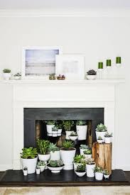 Bright, empty and light blue colored room with big windows. 20 Ways To Dress Up Your Fireplace No Fire Necessary Empty Fireplace Ideas Unused Fireplace Faux Fireplace