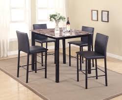 Classy dining room set, featuring a rounded table with a granite tabletop, a beautiful rounded design, and a strong base. Crown Mark Aiden 5 Piece Counter Height Dinette Set With Faux Granite Table Top Royal Furniture Pub Table And Stool Sets