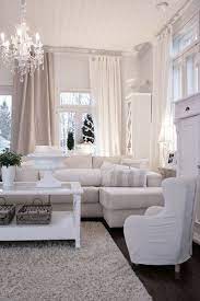 White Feminine Living Room Chandelier And Lots Of Windows Snuggly For Winter Feminine Living Room Beige And White Living Room Home And Living