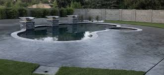 Swimming pool with blue water outdoor. Stamped Concrete For Pool Decking Vs Travertine River Daves Place