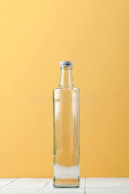 A Glass Low Bottle With A Natural Cork On A White And Yellow Background Stock Image Image Of Liquid Glass 157798231