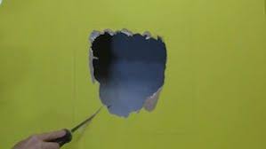 Erect plywood retaining boards in an upright position to create a new corner mold brace for the forthcoming wet concrete repair material. How To Repair Large Holes In Walls And Ceilings Do It Yourself Help Com