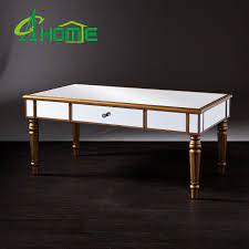 This metal pop up coffee table comes with a large detachable tray with a mirror surface and a foldable base. China Dongguan Home Furniture Champagne Gold Vanity Edge Mirrored Coffee Table China Coffee Table Table
