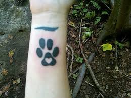 You can get multiple paws, but the single paw is usually a better option since it can fit on more spots of your body. Dog Paws Tattoo On Arm By Zak Schulte