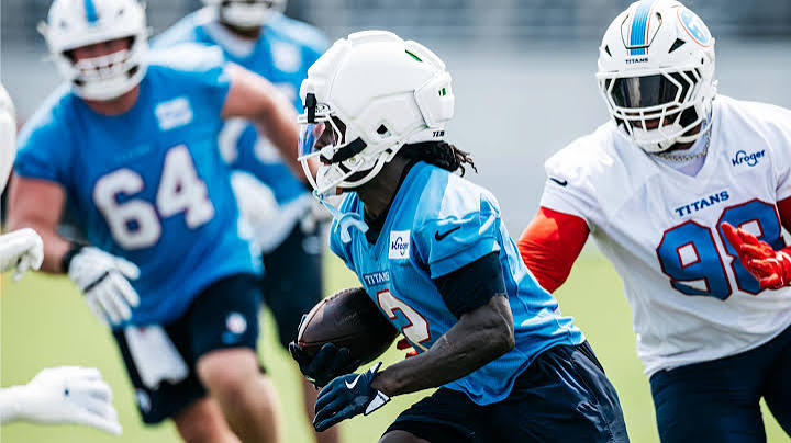 Titans Running Back Tyjae Spears takes the ball for a sprint downfield.