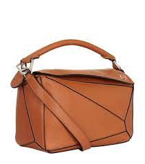 With its innovative cuboid shape, extreme tactility and maximum utility, volume is created through precise cutting so the puzzle bag can be worn in five different ways, from shoulder bag to clutch and folds completely until it's flat. Loewe Small Leather Puzzle Bag Harrods Us