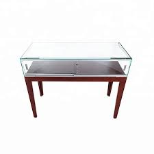 The rectangular coffee table has a tempered glass top for a sleek surface, and the legs of the table are connected and cross at the bottom, creating an x. Glass Top Watch Display Showcase Cherry Wooden Veneer Glass Jewelry Display Table Buy Glass Jewelry Display Table Glass Top Display Table Watch Display Showcase Product On Alibaba Com