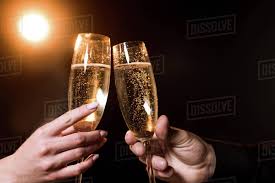 They also make fantastic gifts to congratulate on a job well done or to celebrate a wedding. Cropped Shot Of Couple Clinking Glasses Of Champagne Under Golden Light On Black Stock Photo Dissolve