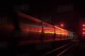 Night Photo Of A Freight Train Passing Red Signals Stock Photo Dissolve