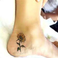A Cute Tattoo Of A Small Sunflower This Tattoo For Girls Is Inked On The Side Of The Heel Colo Sunflower Tattoo Small Small Sunflower Tattoo Sunflower Tattoo