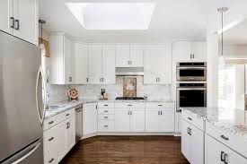 The kitchen features white cabinets, black countertops, black hardware, matte black faucet, black sink a simple design using white cabinets along with black countertop backsplash coveys a bold yet inexpensive. How To Style Your Kitchen Matching Your Countertops Cabinets And Flooring Painterati