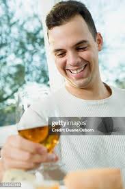 Happy Man Drinking Rose Wine High-Res Stock Photo
