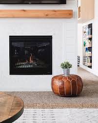 Modern Farmhouse Fireplace With Wood Beam Mantel And Moroccan Pouf Moroccan Pouf Fireplac Modern Fireplace Mantels Wood Fireplace Fireplace Modern Design