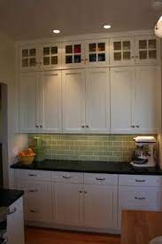Wood curio cabinet with glass door wall mount or table top 16 inches. Glass Doors On Top Lighten The Bank Of Cabinets Without Showing Clutter Traditional Kitchen Top Kitchen Cabinets Kitchen Wall Cabinets Kitchen Remodel Small