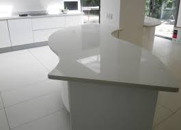 Carrara 20mm island top worktops and even a splash back behind the oven to use as much of the material as possible #quartzcountertops #quartzworktops we love how clean this kitchen looks with the grey starlight quartz worktops contrasting with the white surfaces. Quartz Worktops In Watford
