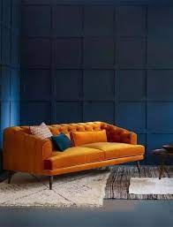 Mustard Yellow Velours Couch In A Dark Blue Room Living Room Orange Orange Sofa Design Blue Rooms