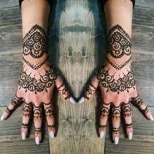This red and black henna tattoo paints a trail from the wrist towards the index finger. 150 Incredible Henna Tattoo Designs Ultimate Guide August 2021