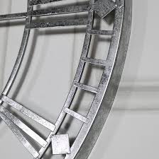 It features the large size, open metal scroll and roman numerals. Extra Large Silver Skeleton Wall Clock
