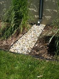 Arrange containers together to create a miniature garden scene. Draining The Rain Water Build Up On East Side Of House With Drain And Rocks Out To Other Rocks Landscape Design Landscape Outdoor Gardens