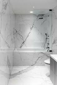 Black And White Marble Tile Designs It Seems Like The Carrara Marble Slabs Always Look Better Than The Carrara Tiles Marble Tile Bathroom White Marble Bathrooms Bathroom Tub