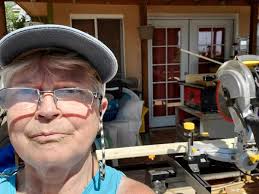 Removing bathroom cabinet hinges with a cordless screwdriver