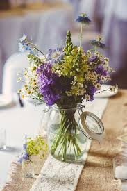 A Vintage Inspired Gown And Pretty Wildflowers In Shades Of Purple Yellow And Blue Wildflower Wedding Purple Wedding Flowers Wedding Flowers