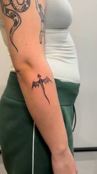 Tiny fineline dragon tattoo, delicate, detailed, and designed to sit subtly on the skin while still carrying real character. Dragons are one of those timeless motifs that work beautifully in a minimal ...