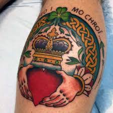 Black and grey claddagh with banner tattoo design. 100 Irish Tattoos Celtic Tattoos And Four Leaf Clover Tattoos For St Patricks Day Tattoo Ideas Artists And Models