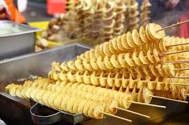 Wash and dry the potatoes, then push a skewer through the middle of each potato lengthways. Hweori Gamja Tornado Potato Daebak