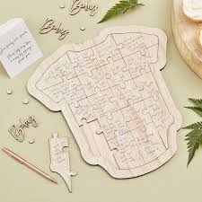 A great alternative guest book at the shower, let your guests sign your guestbook by putting their mark in a bunch of floating balloons. Wooden Baby Shower Guest Book Babygrow Ginger Ray