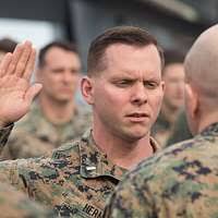 U.S. Navy Lt. Aroon Seeda receives candy from a student