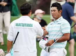 Hideki matsuyama is congratulated by his caddie shota hayafuji on the 18th hole after his 65. Wtgelpjtbuxjvm