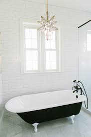 Zillow digs tm luxury primary bathroom with a copper tub and round leather ottoman over flagstone flooring and in between dark wood vanities. Design Tip Free Standing Tubs House Of Jade Interiors