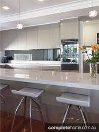 Grey kitchen cupboards white benchtop lathe with white body. White Gloss Cabinetry And Grey Benchtops For The Kitchen Opposite Way Round To This With The Mirrored Splas Grey Kitchen Designs Kitchen Design Kitchen Plans