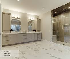 The tile inset feature in bathrooms is really popular these days, and here's another great example of that trend. Casual Dove Gray Painted Bathroom Cabinets Omega