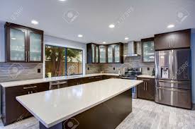 If stained cabinets are part of your kitchen design and you are planning a wood floor, then the stain colors should be complimentary, but do not need to match. Updated Contemporary Kitchen Room Interior With White Counters Stock Photo Picture And Royalty Free Image Image 96303163