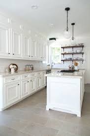 white kitchen cabinets with travertine