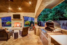 A rustic outdoor entertaining kitchen in dallas features a bar using neolith countertops. Outdoor Kitchens Creekstone Outdoor Living