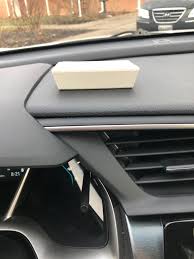 An E-ZPass transponder mounted correctly on the windshield of a car, illustrating proper placement for a successful toll reading.