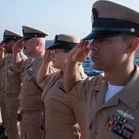 U.S. Navy Petty Officer 2nd Class Dan Kim salutes during