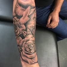A large feather winds its way up the arm, from the wrist up. 1001 Examples Of Stunning Tattoos For Men With Meaning