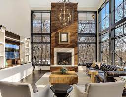 The key in creating pretty kitchen with a very large window is to make sure that you have a bar, dining table or kitchen island on the room. Modern Living Room Features Towering Fireplace Among Floor To Ceiling Windows Pella